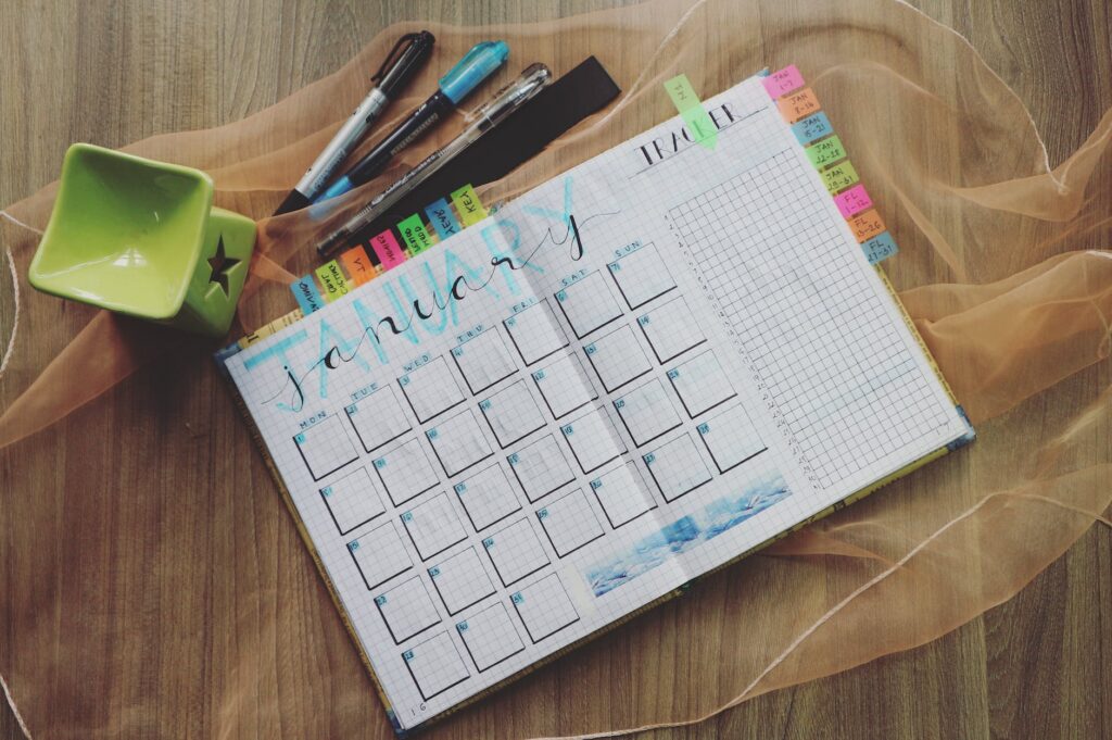 photo of planner and writing materials, create a schedule, stick to schedule. potty training tips